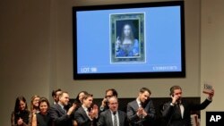 Bidding representatives react after Leonardo da Vinci's "Salvator Mundi" sold for $450 million at Christie's, Wednesday, Nov. 15, 2017, in New York. (AP Photo/Julie Jacobson)