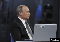 Russian President Vladimir Putin takes part in a live broadcast nationwide call-in in Moscow, April 16, 2015.