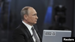 Russian President Vladimir Putin takes part in a live broadcast nationwide call-in in Moscow, April 16, 2015. 