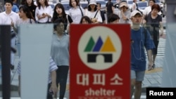 A sign for a bomb shelter is seen at an entrance of a subway station in Seoul, South Korea, Aug. 11, 2017. 