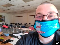 This June 2020 selfie photo shows Bill Mathis of Romeo, Mich., in one of the rooms where he taught high school English. (AP Photo via Bill Mathis)