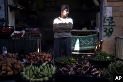 In this Sept. 10, 2018, photo, a vendor waits for clients in the market of the northern city of Idlib, Syria. Syrian government forces, backed by Russia and Iran, have been massing troops for weeks in preparation for an attack on Idlib province, the last major rebel stronghold in the country.