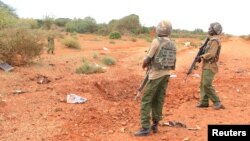 FILE - A Kenyan security officer stands at the scene where a blast killed Kenyan policeman at the Garissa county, eastern Kenya, May 24, 2017.