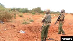 FILE - A Kenyan security person stands at the scene where a blast killed Kenyan police officers at the Garissa county, eastern Kenya, May 24, 2017.