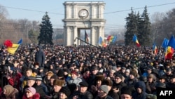 People attend the rally in front of the Parliament building in Chisinau on January 21, 2016. 