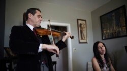 Musicians David Shenton and Erin Shields perform inside their home in the Queens borough of New York on March 30, 2021.