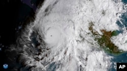 This GOES East satellite image provided by NOAA shows Hurricane Willa in the eastern Pacific, on a path toward Mexico's Pacific coast on Oct. 22, 2018. 