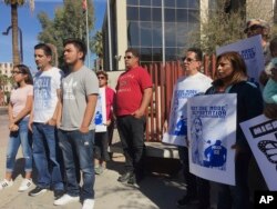 Members of the family of Guadalupe Garcia de Rayos, left, stand with supporters at a news conference in front of the U.S. Immigration and Customs Enforcement office in Phoenix. Garcia de Rayos was deported Feb. 9, 2017.