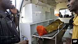 The body of Abdulai Bah, 20, allegedly shot by Guinean soldiers, lays in an ambulance in the mostly Peul suburb of Bambeto in Conakry, Guinea, 17 Nov. 2010