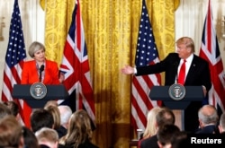 FILE - British Prime Minister Theresa May listens as U.S. President Donald Trump speaks during their joint news conference at the White House in Washington, Jan. 27, 2017.