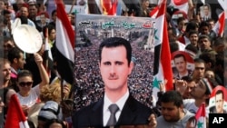 Supporters of Syrian President Bashar al-Assad rally at al-Uomawien square, Damascus, Oct. 26, 2011.
