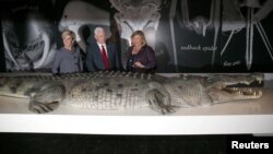 FILE - U.S. Vice President Mike Pence, center, observes a life-size replica of an Australian saltwater crocodile during his visit to the Australian Museum with Australian Foreign Minister Julie Bishop, left, and the museum's Executive Director Kim McKay in Sydney, Australia, April 22, 2017. (REUTERS/David Moir/Pool)