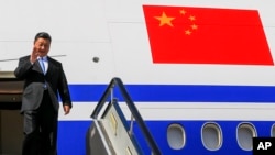 FILE - Chinese President Xi Jinping gestures as he arrived at Vladivostok, Russia, to attend the Eastern Economic Forum, Sept. 11, 2018. 