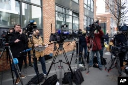 Reporters gather outside the police station where former French President Nicolas Sarkozy was being held in Nanterre, outside Paris, March 21, 2018.