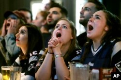 Kathleen Doherty, center, of Woburn, Mass., reacts with other fans at a Boston bar while watching the New England Patriots' final drive during the first half of the NFL Super Bowl 52 football game between the Patriots and the Philadelphia Eagles in Minnea