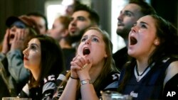 Kathleen Doherty, center, of Woburn, Mass., reacts with other fans at a Boston bar while watching the New England Patriots' final drive during the first half of the NFL Super Bowl 52 football game between the Patriots and the Philadelphia Eagles in Minneapolis, Sunday, Feb. 4, 2018.