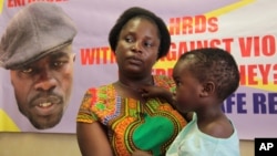 FILE - Sheffra Dzamara, wife of activist Itai Dzamara, holds her 2-year-old daughter and speaks to The Associated Press in Harare, March 8, 2016. Dzamara was pleading for the return of her activist husband, abducted by suspected state security agents.