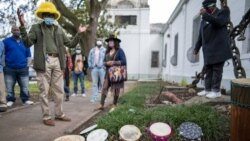 Darryl Montana, left, the son of the late Big Chief Allison "Tootie" Montana, joins others at the blessing of the tambourines outside St. Augustine Catholic Church for the start of Twelfth Night in New Orleans on Wednesday, Jan. 6, 2021. (Chris Granger)