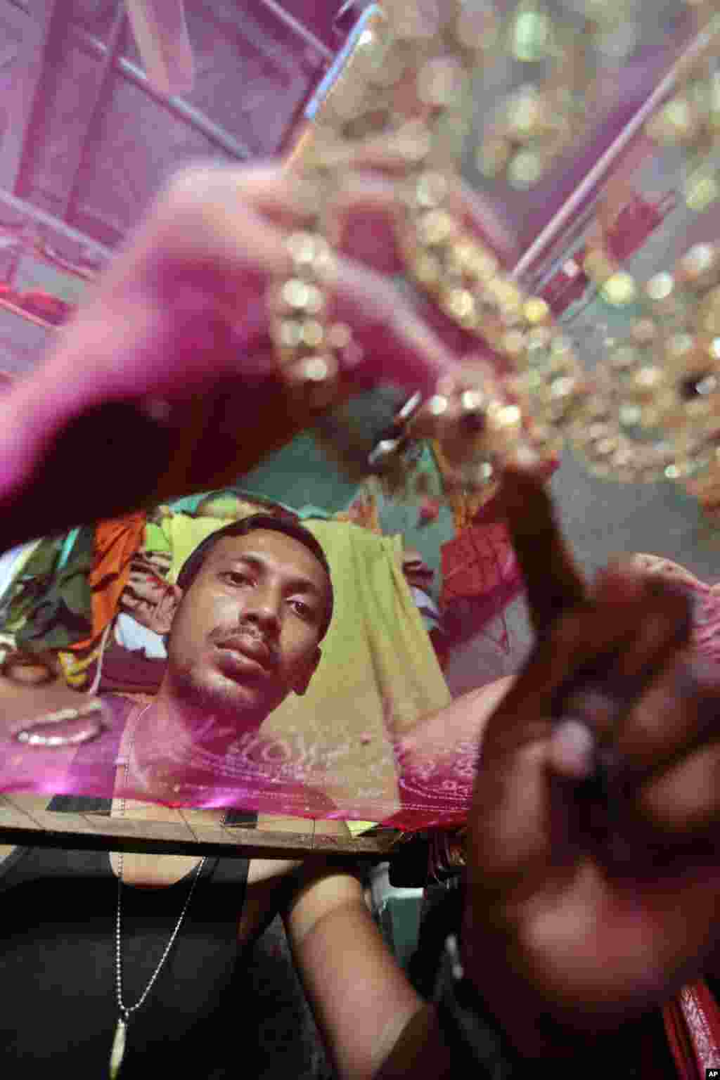 A Bangladeshi man works at an embroidery factory before Eid al-Fitr celebrations in Dhaka, Bangladesh, July 30, 2013. 