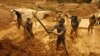 Artisanal miners dig for gold in an open-pit concession near Dunkwa, western Ghana, February 15, 2011.