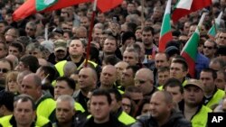 FILE - Hundreds of Bulgarian policemen, prison guards and firemen rally in front of the Parliament building in Sofia, Nov 8, 2015, protesting planned benefit cuts. Sinking wages and living standards have been a major driver of anti-government sentiment in the former Soviet bloc country.