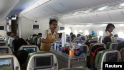 Female crew members serve lunch on board an Ethiopian Airlines flight from Addis Ababa Nairobi, April 27, 2013.