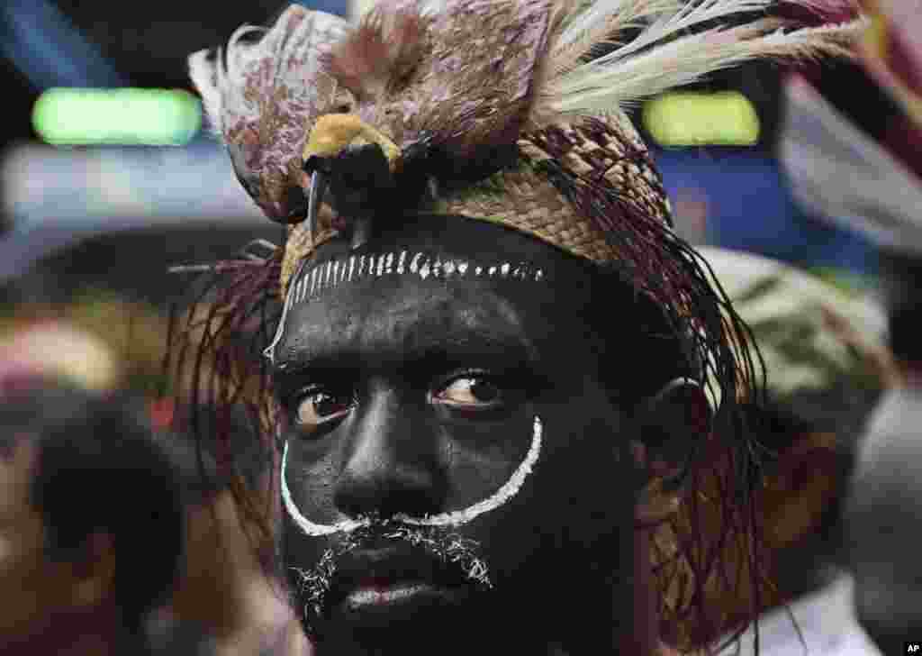 A Papuan activist donning a traditional headwear with a stuffed bird of paradise attends a protest against U.S. mining giant Freeport-McMoRan Copper & Gold Inc. in Jakarta, Indonesia. Activists demands the New Orleans-based mining company close its mine in Papua province saying that it siphons off the region's wealth and gives it little in return.