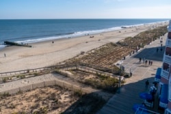 The beach and boardwalk are seen, Friday, Nov. 13, 2020, in Rehoboth Beach, Del. President-elect Joe Biden owns a $2.7 million, Delaware North Shores home with a swimming pool that overlooks Cape Henlopen State Park. (AP Photo/Alex Brandon)