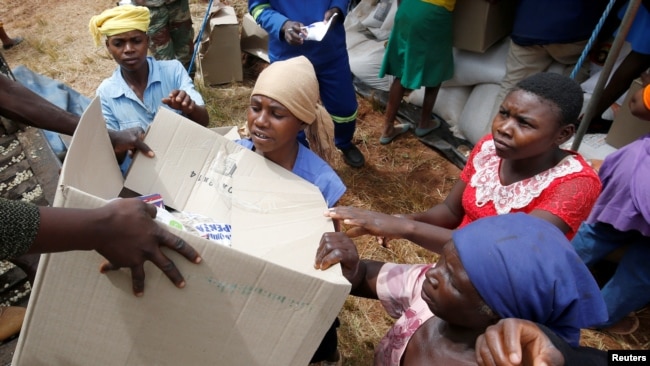 FILE - Victims of Cyclone Idai receive food aid at Siverstream Estates in Chipinge, Zimbabwe, March 24, 2019.
