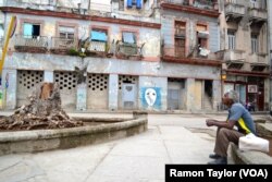 A man takes a cigarette break in Plazuela de Albear, three blocks from "el capitolio," in Havana, Cuba, March 21, 2016.