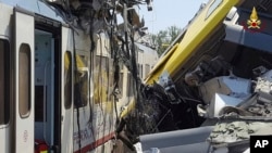 Crumpled wagon cars are seen after after two commuter trains collided head-on near the town of Andria, in the southern region of Puglia, killing several people, July 12, 2016.