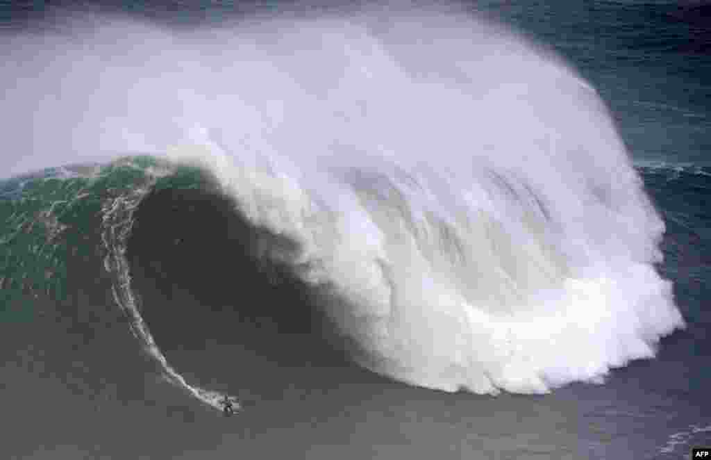 Spanish surfer Axier Muniain rides a wave during the Nazare Tow Surfing Challenge in Nazare, Portugal.