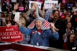 Supporters of Republican presidential candidate, Donald Trump, cheer as he arrives to speak during a campaign rally, in Denver, Colorado, Nov. 5, 2016.
