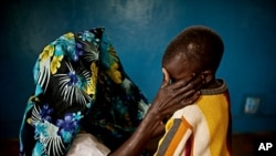 A mass rape victim comforts her son in the town of Fizi, Democratic Republic of Congo, February 20, 2011