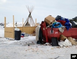 Trash is piled in and around a dumpster at an encampment set up near Cannon Ball, North Dakota., Feb. 8, 2017, for opponents against the construction of the Dakota Access pipeline.