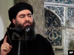 FILE - This image made from video posted on a militant website July 5, 2014, purports to show the leader of the Islamic State group, Abu Bakr al-Baghdadi, delivering a sermon at a mosque in Mosul, Iraq, during his first public appearance.