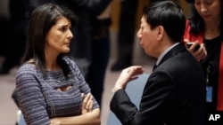 FILE - U.S. Ambassador to the United Nations Nikki Haley talks with Chinese Deputy Ambassador Wu Haitao, Dec. 22, 2017, at United Nations headquarters ahead of a council vote on proposed new sanctions against North Korea.