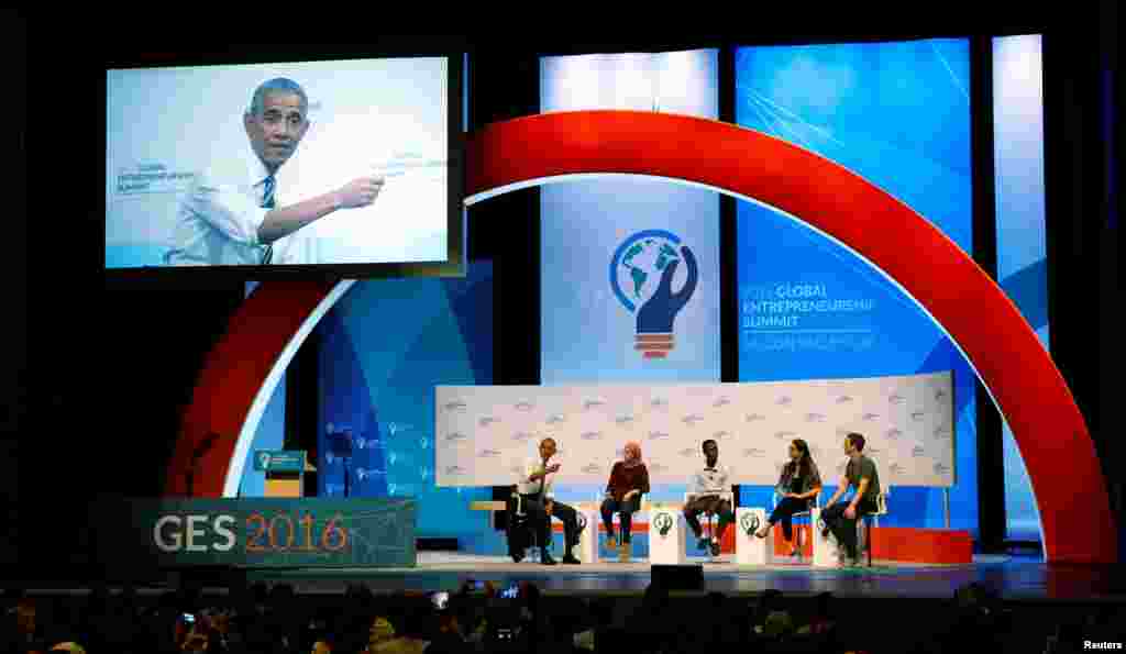 A huge monitor projects U.S. President Barack Obama as he takes part in a discussion with Mark Zuckerberg (R) and entrepreneurs at the Global Entrepreneurship Summit at Stanford University in Palo Alto, California.