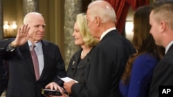 Vice President Joe Biden administers the Senate oath of office to Sen. John McCain, R-Ariz., accompanied by his wife, Cindy McCain, and his family during a a mock swearing-in ceremony in the Old Senate Chamber on Capitol Hill in Washington, Jan. 3, 2017.