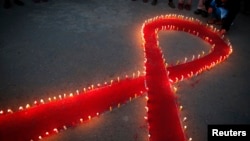 Women and children from "Maiti Nepal," a rehabilitation center for victims of sex trafficking, light candles on the eve of World AIDS Day in Kathmandu, Nepal, Nov. 30, 2016. World AIDS Day is observed on December 1 every year to raise the awareness in the fight against HIV. 