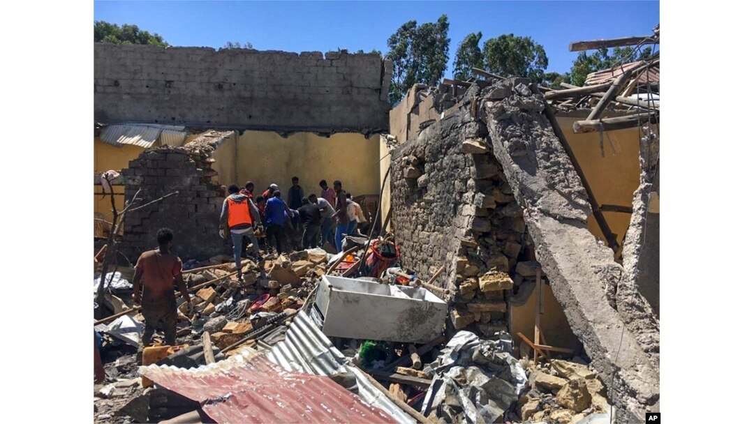 FILE - Residents sift through rubble from a destroyed building at the scene of an airstrike in Mekelle, in the Tigray region of northern Ethiopia, Oct. 28, 2021.