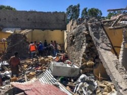 Residents sift through rubble from a destroyed building at the scene of an airstrike in Mekelle, in the Tigray region of northern Ethiopia, Oct. 28, 2021.