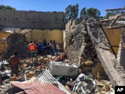 FILE - Residents sift through rubble from a destroyed building at the scene of an airstrike in Mekelle, in the Tigray region of northern Ethiopia, Oct. 28, 2021.