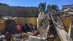 FILE - Residents sift through rubble from a destroyed building at the scene of an airstrike in Mekelle, in the Tigray region of northern Ethiopia, Oct. 28, 2021.