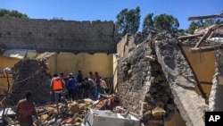 FILE - Residents sift through rubble from a destroyed building at the scene of an airstrike in Mekelle, in the Tigray region of northern Ethiopia, Oct. 28, 2021.