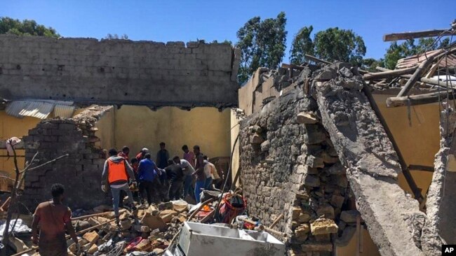 FILE - Residents sift through rubble from a destroyed building at the scene of an airstrike in Mekelle, in the Tigray region of northern Ethiopia, Oct. 28, 2021.
