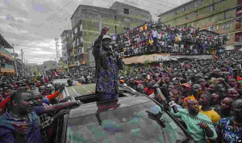 Kenyan opposition leader Raila Odinga speaks to thousands of supporters gathered in the Mathare area of Nairobi. Odinga condemned police killings of rioters during protests after the country&#39;s disputed election and is urging supporters to skip work Monday.