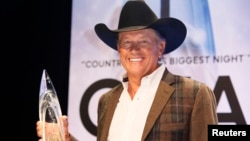 George Strait poses backstage with his Entertainer of the Year award at the 47th Country Music Association Awards in Nashville, Tennessee, Nov. 6, 2013. 