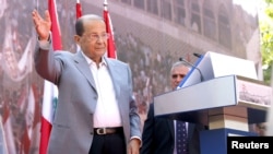 Lebanese Christian leader and founder of the Free Patriotic Movement (FPM) Michel Aoun greets his supporters during a rally to show support for him and to mark the October 13 anniversary, near the presidential palace in Baabda, near Beirut, Oct. 11, 2015.