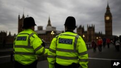 FILE - Police officers patrol Westminster Bridge with the Houses of Parliament in the background, in London, Britain, June 8, 2017.